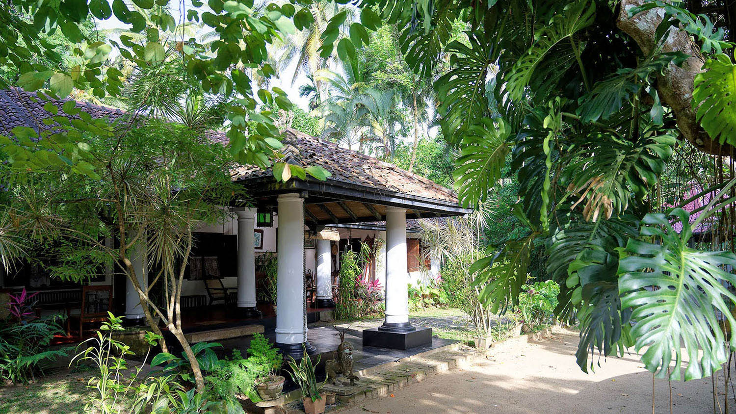 Suriyakantha walawwa entrance veranda framed by lush garden